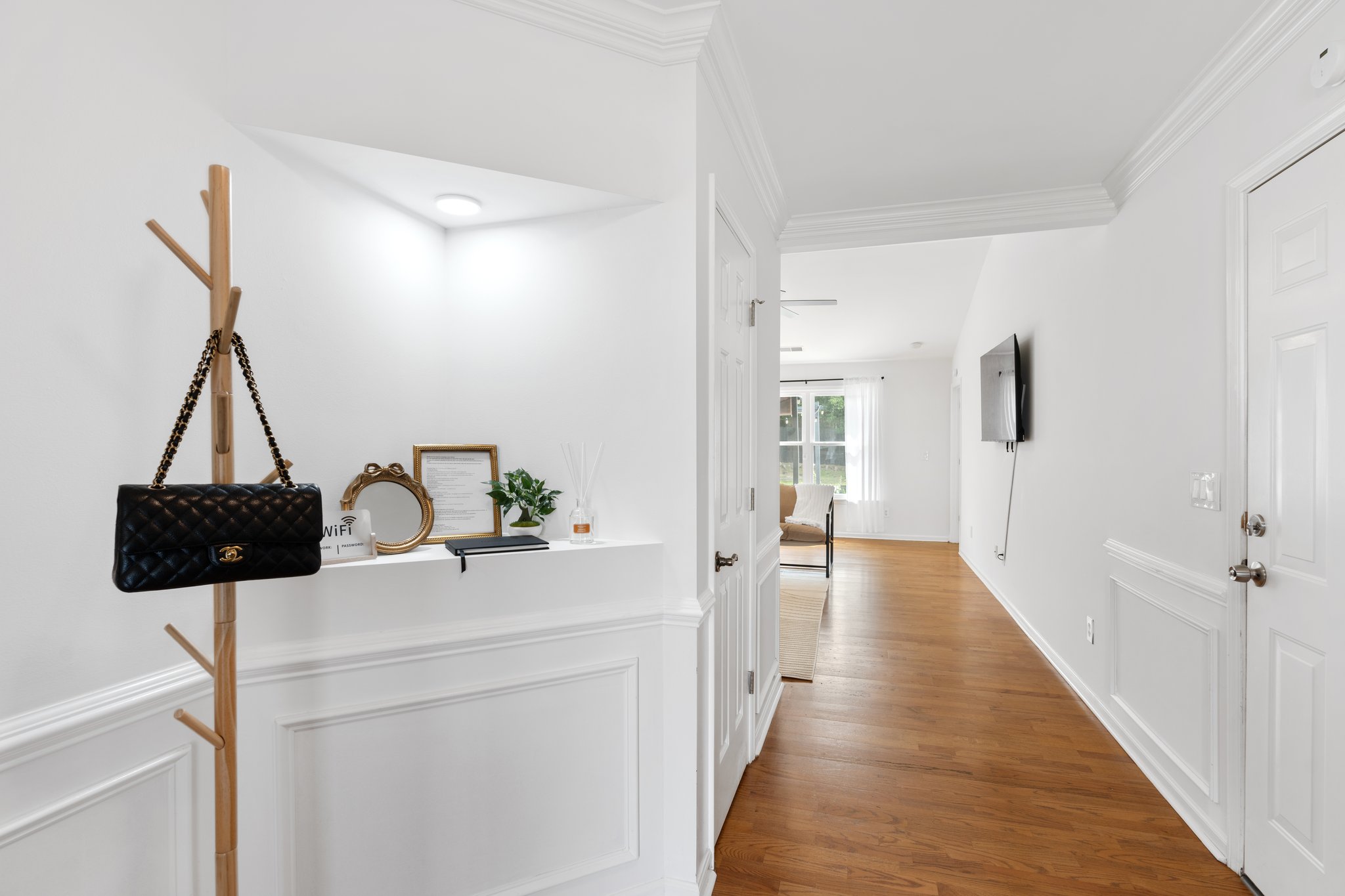 Elegant hallway with dark wood accents, decorative shelving, and refined interior design at Greenville home