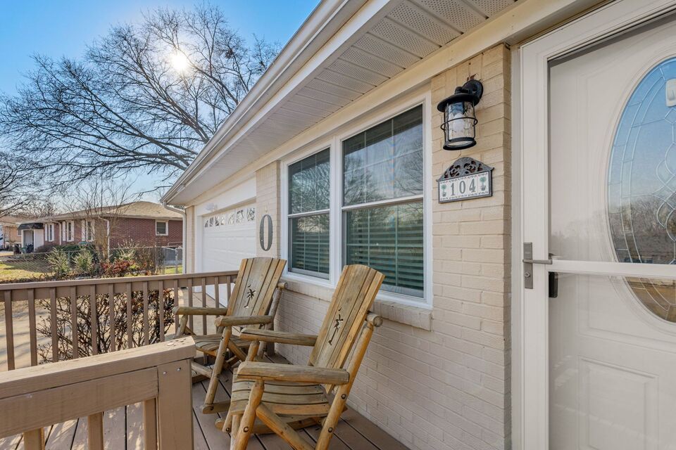 Welcoming front porch with wooden Adirondack chairs and scenic neighborhood views at Pendleton vacation home